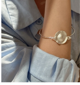 Close-up of S925 sterling silver cuff with matte hammered texture on a model's wrist