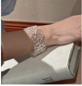 Detail of the 925 sterling silver cuff bracelet with intricate woven texture on a wrist