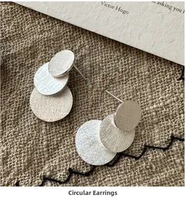 Macro shot of S925 sterling silver earrings with triple overlapping brushed metal circles