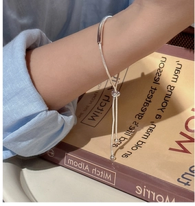Macro detail of adjustable S925 sterling silver hollow tube bracelet with slider clasp