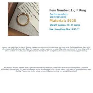 Macro detail of minimalist S925 sterling silver band ring with polished gold plating finish