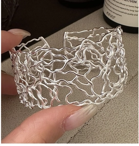 Detailed view of silver hollowed-out irregular lines on this vintage 925 silver bangle