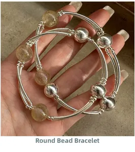 Detail of S925 sterling silver beaded bracelet with rutilated quartz on hand