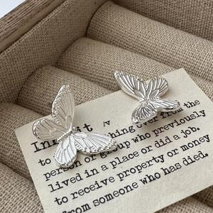 Elegant S925 sterling silver butterfly stud earrings with detailed wing texture on vintage card