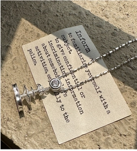 Macro detail of S925 sterling silver beaded necklace with tiered fountain pendant and zircon