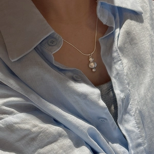 Minimalist S925 sterling silver snake chain necklace with stacked pebble pendant on a model