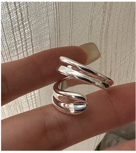 Macro detail of silver adjustable criss-cross ring with irregular lava texture