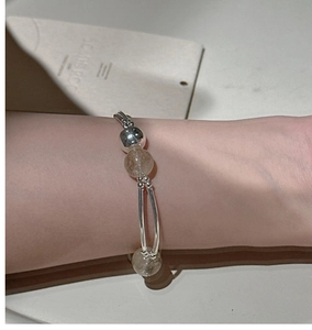 Detail of S925 sterling silver rutilated quartz bracelet worn on wrist for daily use