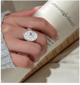 Macro detail of S925 sterling silver daisy relief ring with sparkling zircon stone