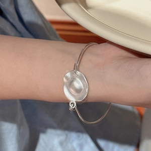Minimalist S925 sterling silver cuff bracelet with a hammered irregular round charm