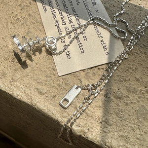 Minimalist S925 sterling silver fountain necklace with crystal pendant on stone surface