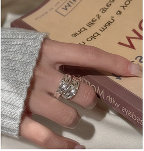 Close-up of minimalist S925 sterling silver wavy ring worn on index finger for women