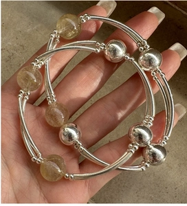 Detailed close-up of S925 sterling silver rutilated quartz beaded stretch bracelet