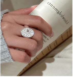 Macro detail of S925 sterling silver ring featuring an embossed daisy floral relief
