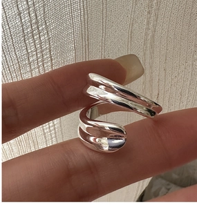 Close-up of minimalist S925 sterling silver ring with irregular wavy twisted design