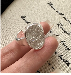Macro detail of S925 sterling silver flower ring with zircon stone and vintage texture