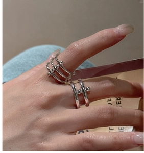 Detailed view of S925 sterling silver double-layered rings with small metal bead accents