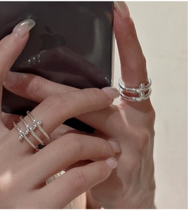 Detail of S925 sterling silver layered rings shown on hand for a minimalist aesthetic