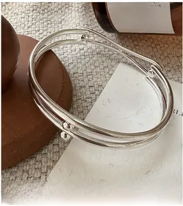 Detail shot of a double-layered S925 silver cuff bracelet with minimalist bead accents