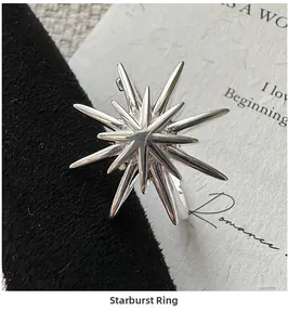 Close-up of S925 sterling silver starburst ring on a black velvet gift display