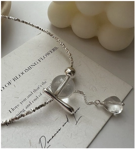 Macro detail of S925 sterling silver chain with clear crystal and water drop pendant
