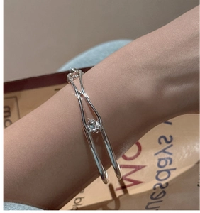 Close-up of S925 sterling silver double-layered bangle with polished beads on wrist