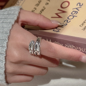 Minimalist S925 sterling silver multi-layer crossover ring shown on model finger