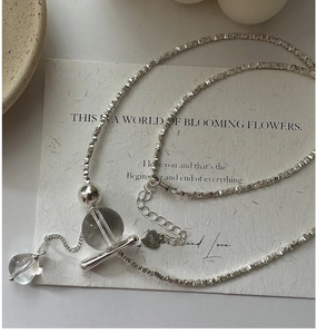 Macro shot of S925 sterling silver tassel necklace with crystal ball and heart tag