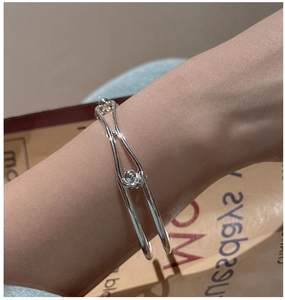 Close-up of a minimalist S925 sterling silver double-layer cuff bracelet on wrist