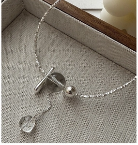 Detail of S925 sterling silver tassel necklace with white crystal and toggle clasp