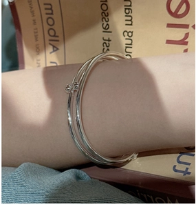 Detail of S925 sterling silver triple layered bangle with small polished sphere pendants