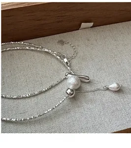 Detail of S925 silver fringe necklace with cotton beads and water-drop pearl pendant