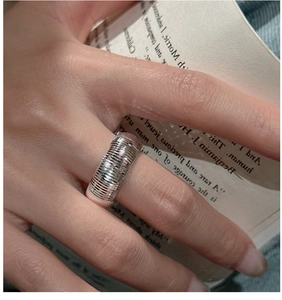 Detailed close-up of wide S925 sterling silver ring with fine textured surface