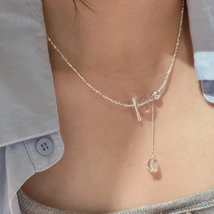 S925 sterling silver Y-necklace with white crystal beads and tassel drop on a model