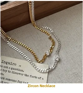 Detail of S925 silver curb chain necklace with a single round zircon in gold and silver