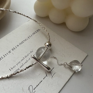 S925 sterling silver necklace with clear crystal beads and fringe tassel on art paper