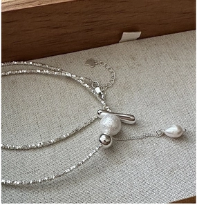 Detail of S925 sterling silver tassel necklace with crushed silver beads and pearls