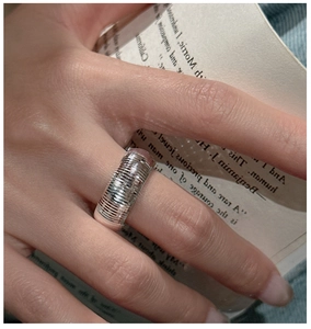 Macro shot of a wide S925 sterling silver ring with fine horizontal CNC texture details