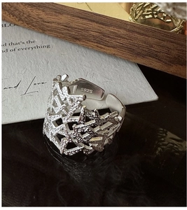 Macro shot of S925 sterling silver ring featuring irregular textured hollow design