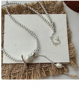 Detail of S925 sterling silver beaded necklace with cotton shell pearl and tassel