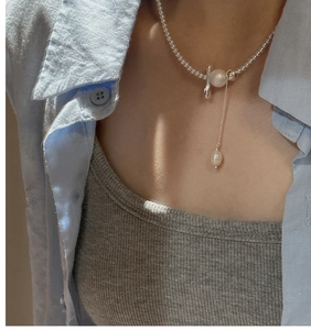 Detail view of S925 silver beaded tassel necklace with a T-bar clasp and baroque pearl pendant