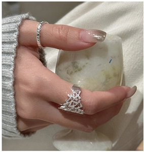 Macro detail of S925 sterling silver rings with hollow cross lines and wavy textures