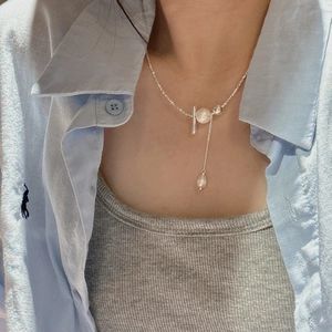 S925 sterling silver tassel necklace with cotton pearl and bar pendant on a woman's neck