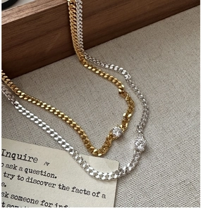 Detail view of gold and silver S925 sterling silver necklaces with cubic zirconia gems