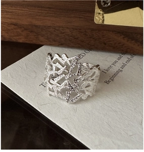 Detailed shot of textured S925 sterling silver ring with irregular hollow geometry