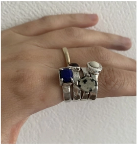 Close-up of vintage silver stackable rings with blue and spotted natural stones