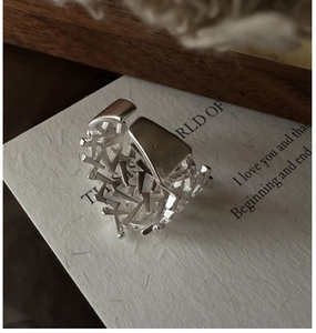 Macro view of textured S925 sterling silver ring with irregular hollow geometric design