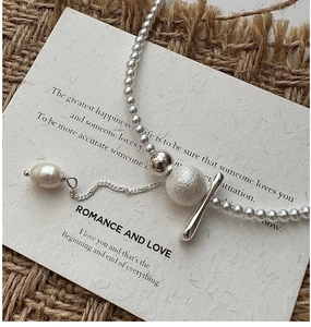Detail of S925 silver necklace featuring baroque pearl and mixed bead tassel charms