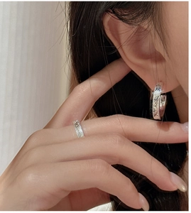 Detail of silver S925 sterling silver textured honeycomb hoop earring and ring set on model