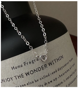 Close-up of S925 sterling silver necklace with a single round zircon pendant